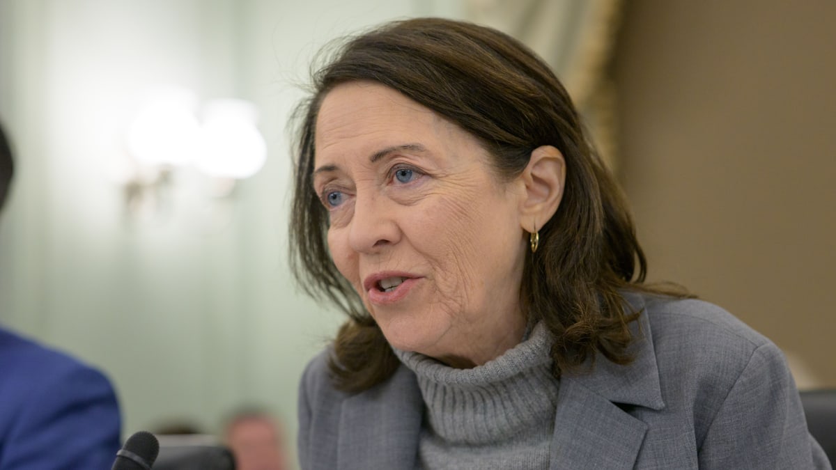 Sen. Maria Cantwell, in a gray jacket and turtleneck, speaks at a Senate Commerce Committee hearing in the Russell Senate Office Building