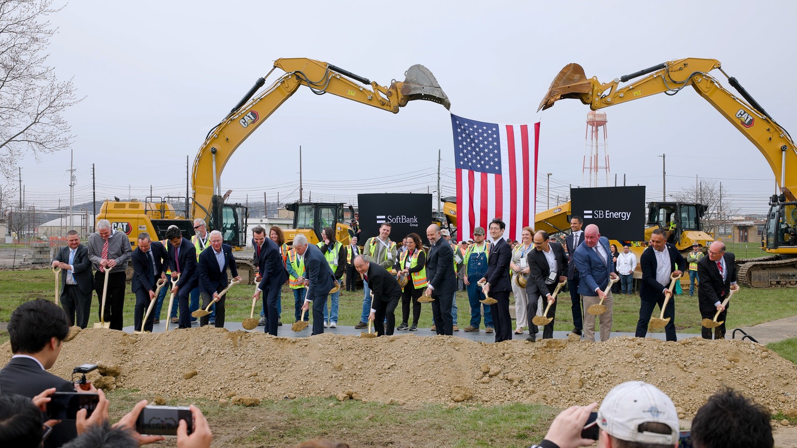 DOE Environmental Management still of SoftBank and SB Energy groundbreaking at the Portsmouth Site with excavators and U.S. flag