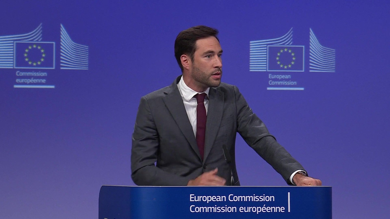 European Commission spokesperson speaking at the Midday press briefing podium in the Berlaymont, Brussels