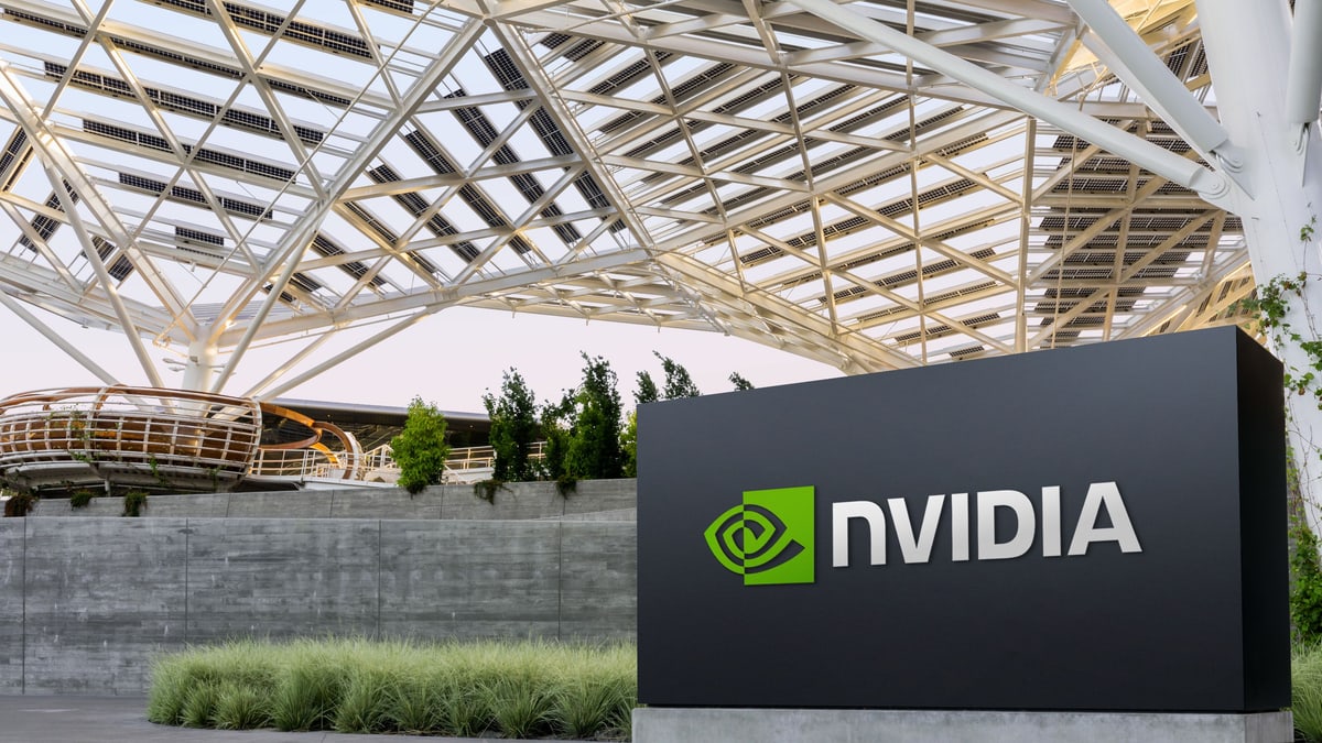 NVIDIA sign in front of a company building under a white steel canopy