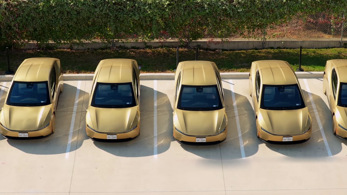 A row of gold Tesla Cybercabs with Texas plates parked side by side, from Tesla's video marking 300 Cybercabs in Austin
