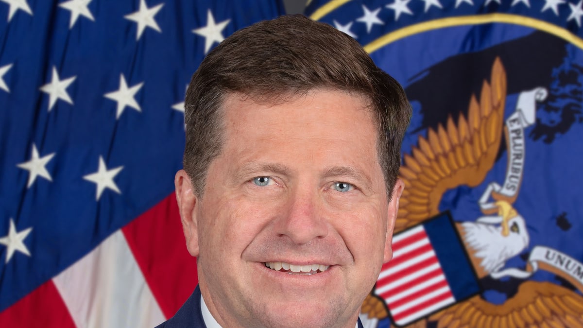 Official portrait of Director of National Intelligence Jay Clayton in front of a U.S. flag and the intelligence community seal
