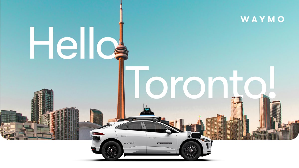 A white Waymo self-driving car in front of the Toronto skyline and the CN Tower, from Waymo's announcement of its Toronto plans