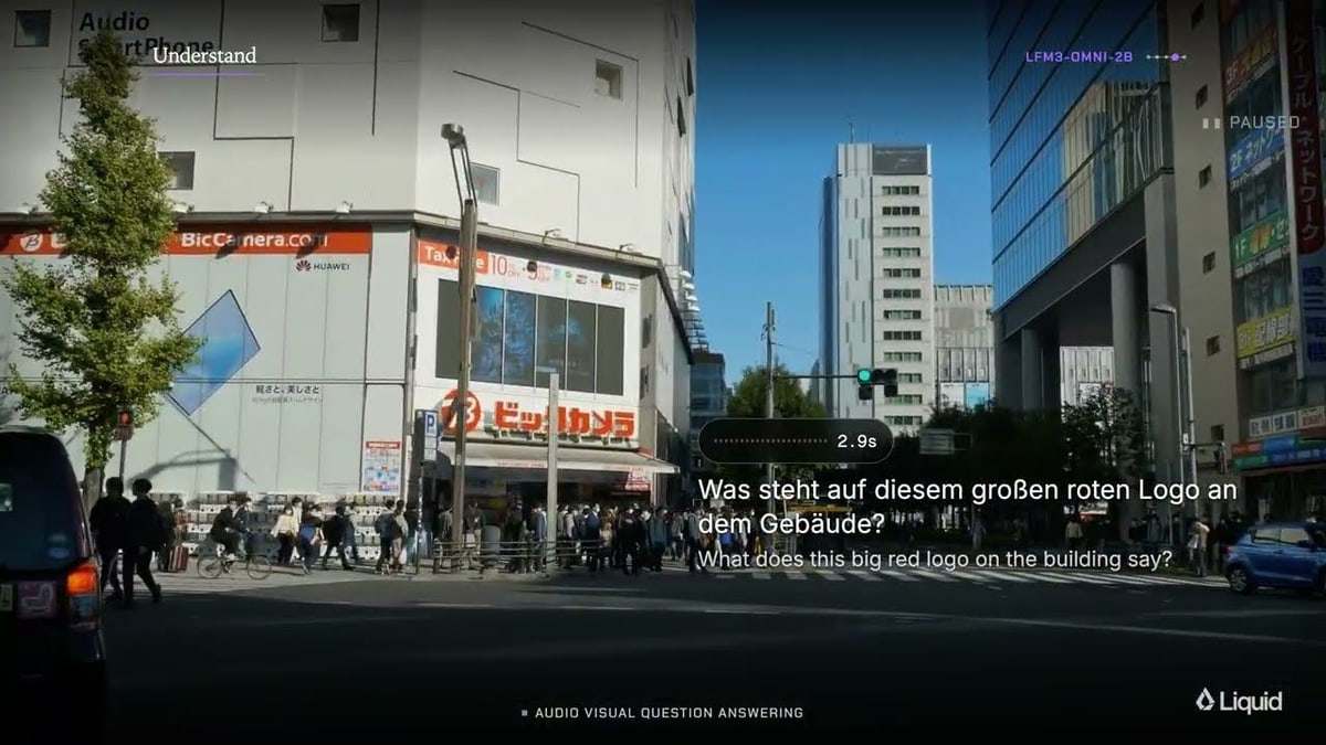 A busy city street with shops and office towers, with a spoken question in German and its English translation: what does this big red logo on the building say?