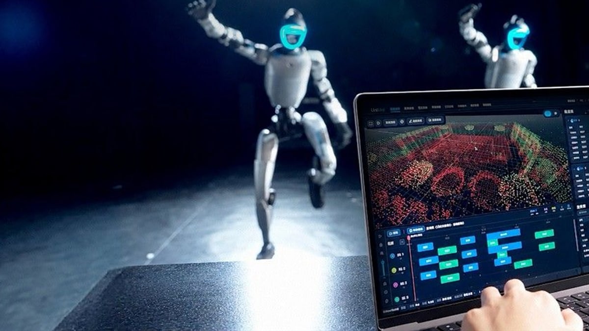 Two of Unitree's humanoid robots dancing on a dark stage behind a laptop showing the UniUni app's 3D dot map of the stage and its timeline of moves, with a hand on the keyboard