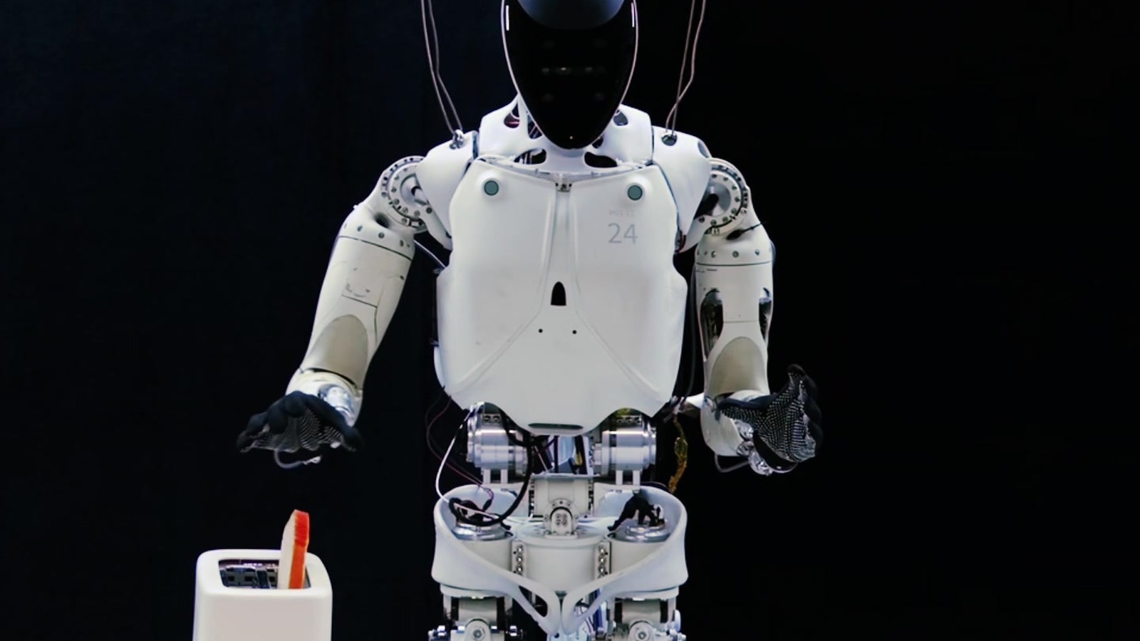 XPENG IRON humanoid mid bread-transfer demonstration still from the XPACE project demos: joint world-action model on heterogeneous video