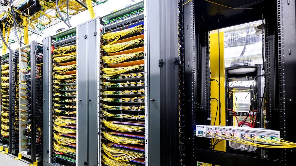Rows of server racks packed with yellow cables inside an Amazon data center