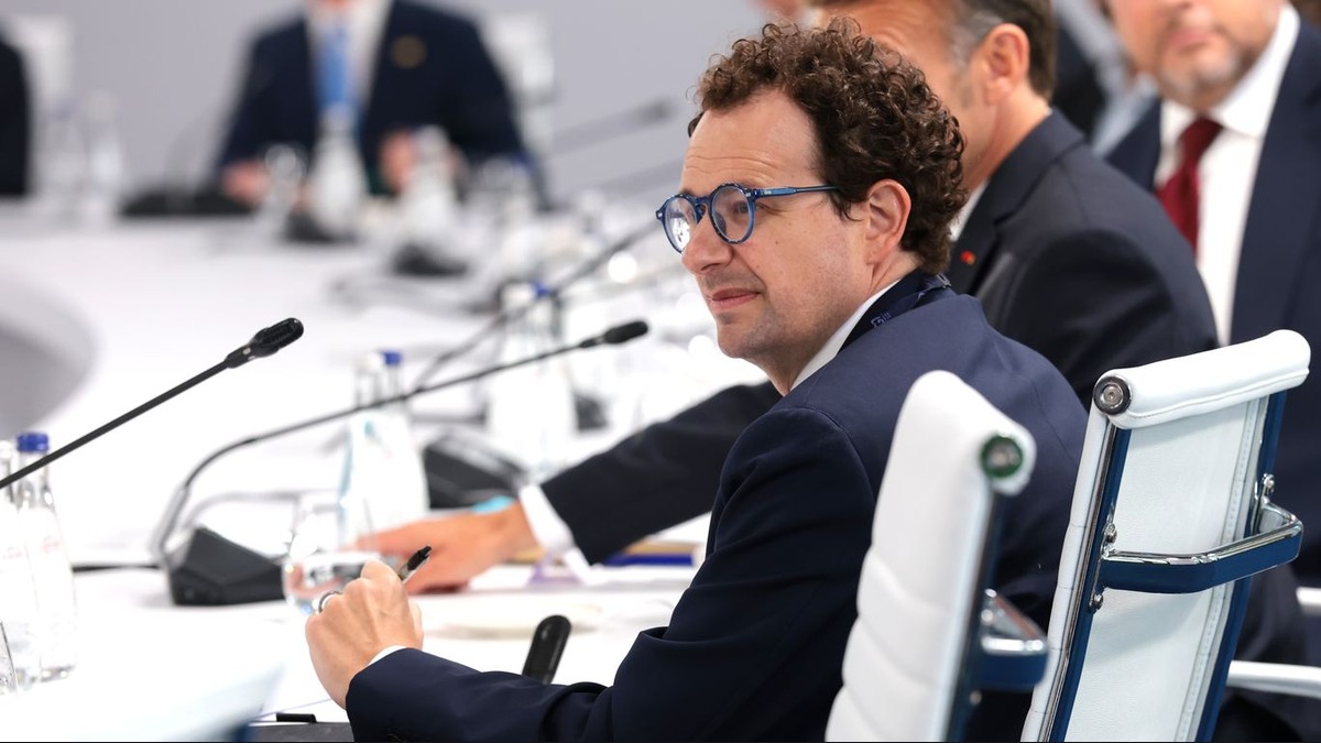 Anthropic CEO Dario Amodei seated at a formal conference table