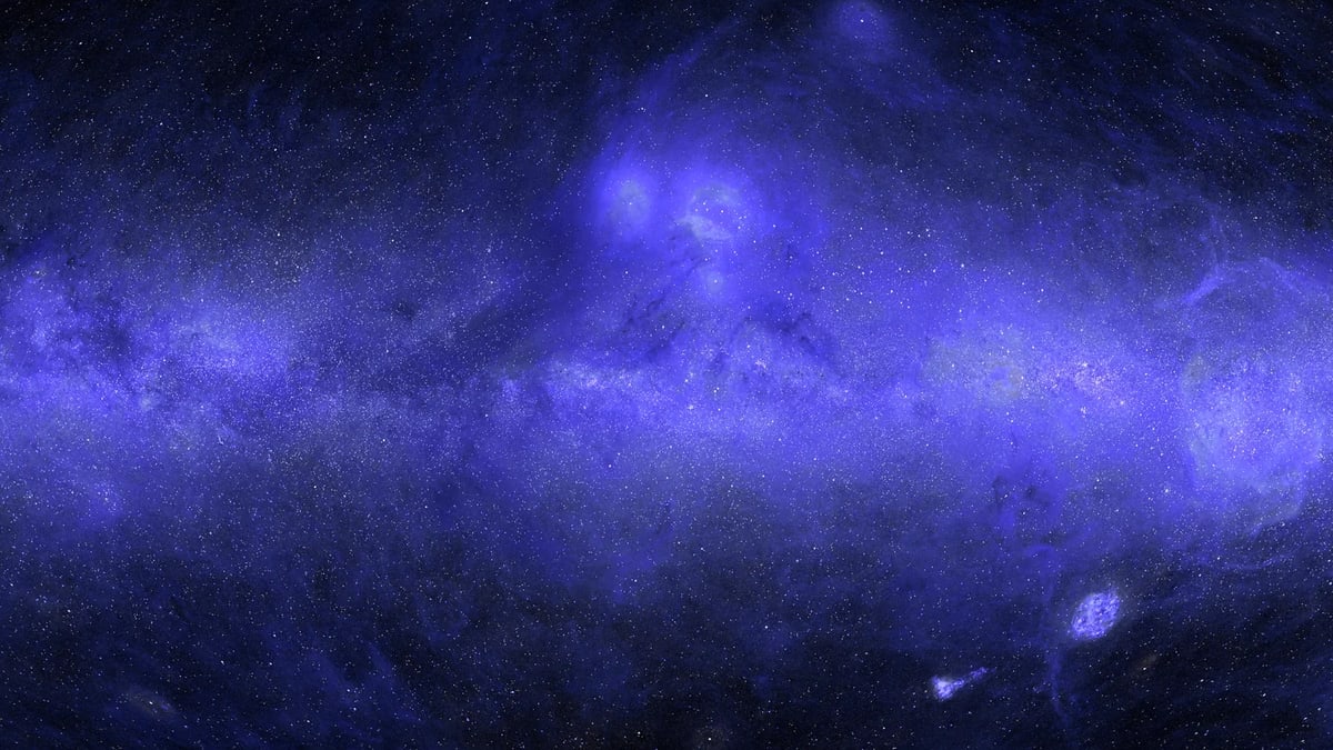 The ultraviolet sky map: a broad blue-violet band of glowing dust along the Milky Way across a field of stars, with bright clouds above the center and the two Magellanic Clouds at lower right