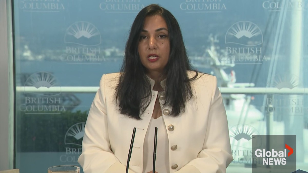 British Columbia Attorney General Niki Sharma speaks at a provincial press conference with BC government branding behind her