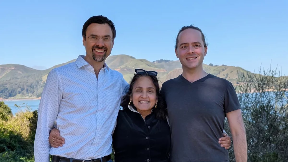 AISLE co-founders Ondrej Vlcek, Jaya Baloo and Stanislav Fort, from left, standing together outdoors with green hills and water behind them