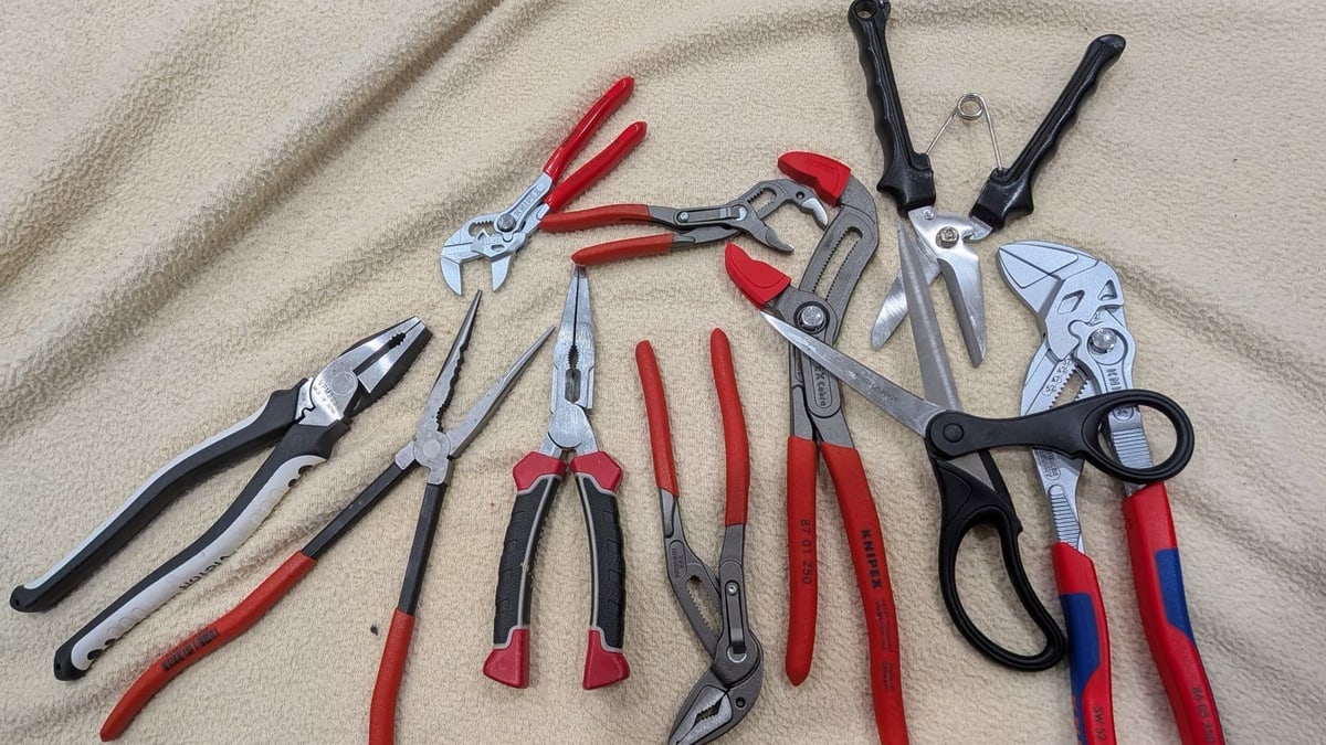 Open and closed pliers mixed with scissors and other tools on a cloth, from Elorian's counting example