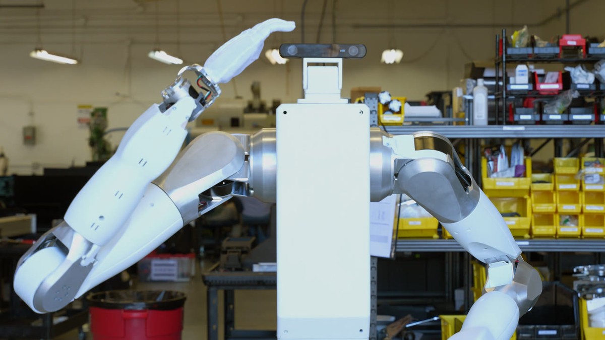 Feather wheeled bimanual humanoid developer platform in a warehouse aisle