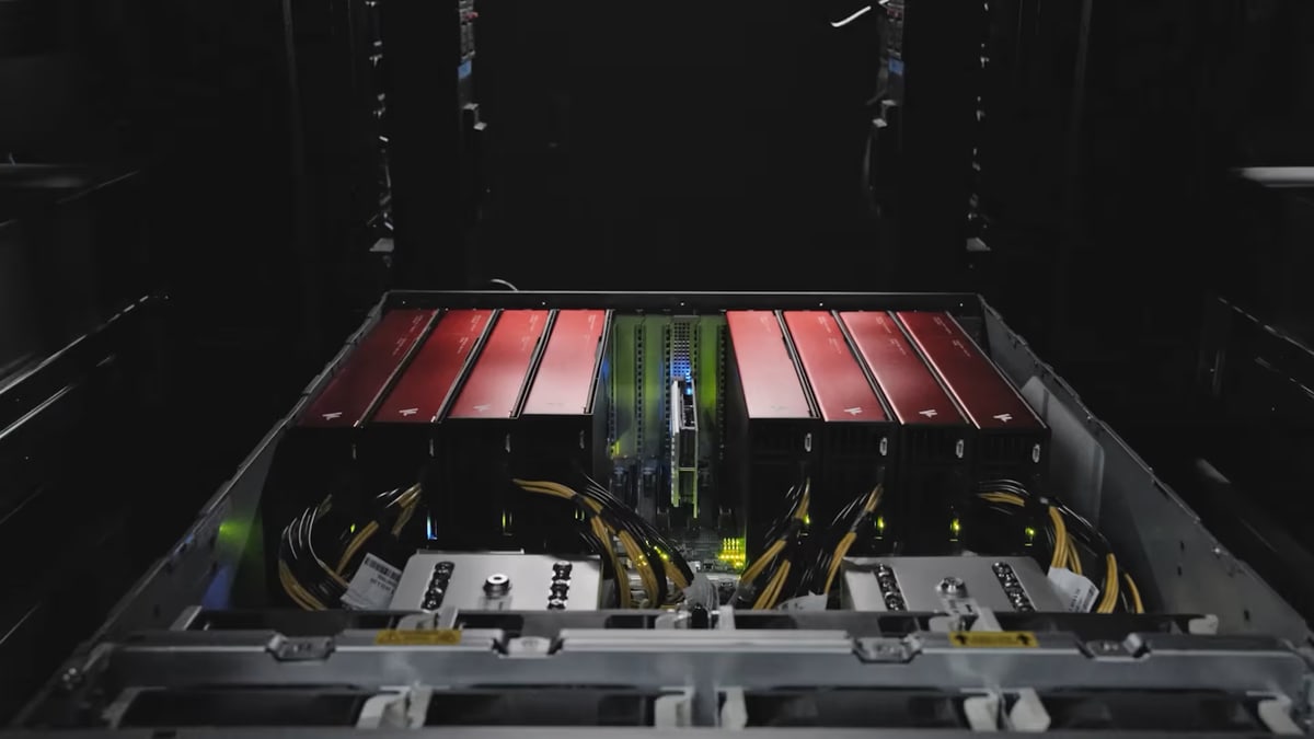 Eight of FuriosaAI's red RNGD chip cards installed side by side in an open server in a data center rack
