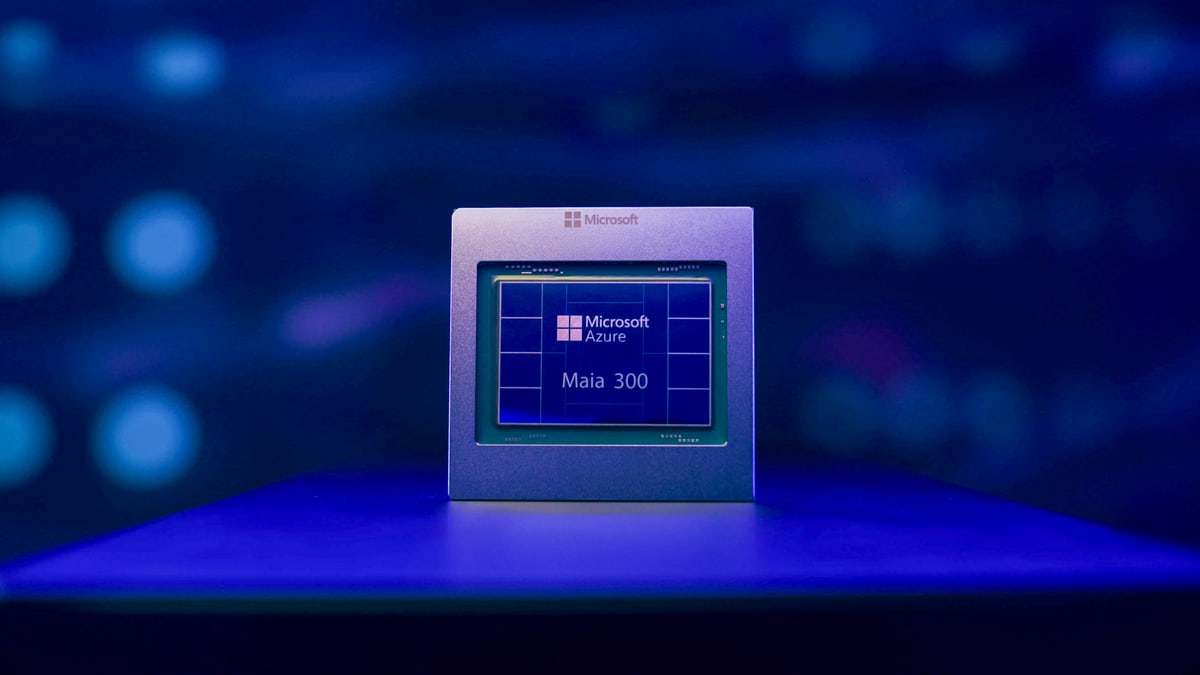 Microsoft's Maia 300 AI chip, labeled Microsoft Azure Maia 300, standing on a lit surface against a dark blue background