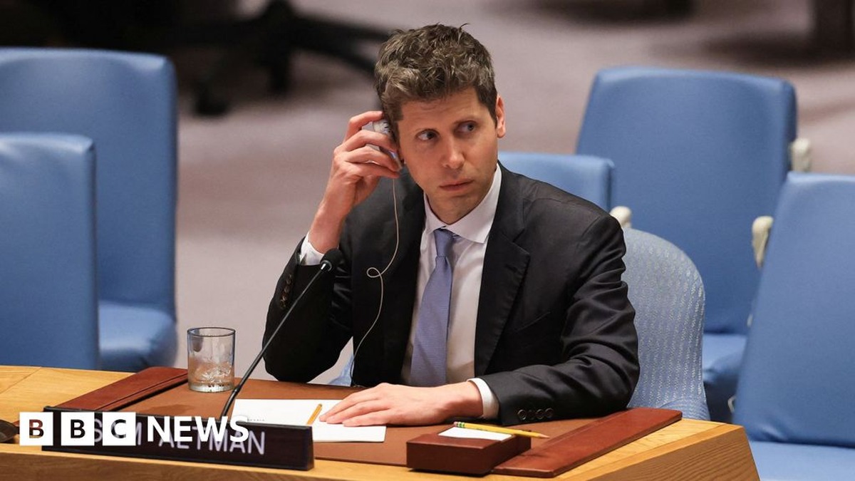 OpenAI CEO Sam Altman seated at a formal conference desk