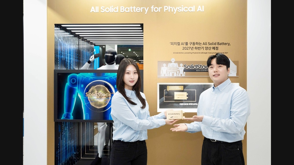 Samsung SDI presenters holding a SolidStack all-solid-state battery sample beside a Physical AI display with a humanoid robot