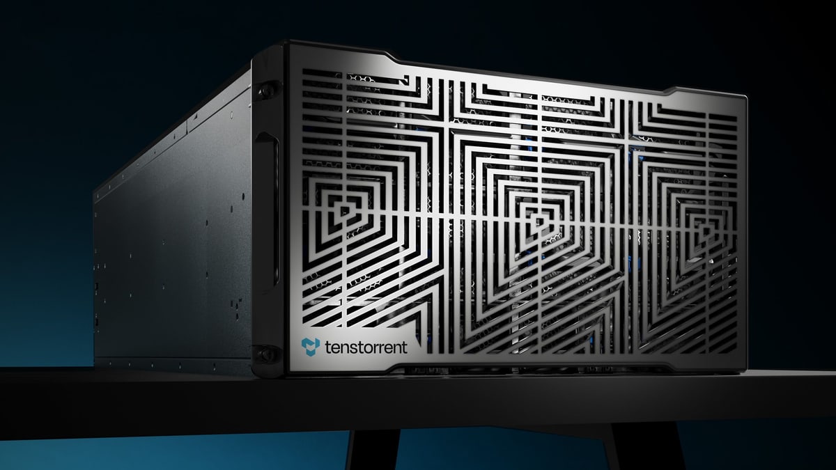 A Tenstorrent AI server with a patterned metal front panel, on a dark table